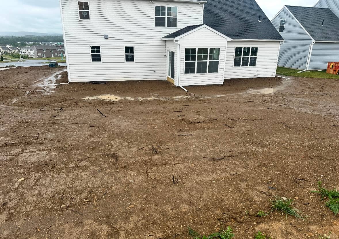 Open lawn and finished yard after the drainage and hardscape work