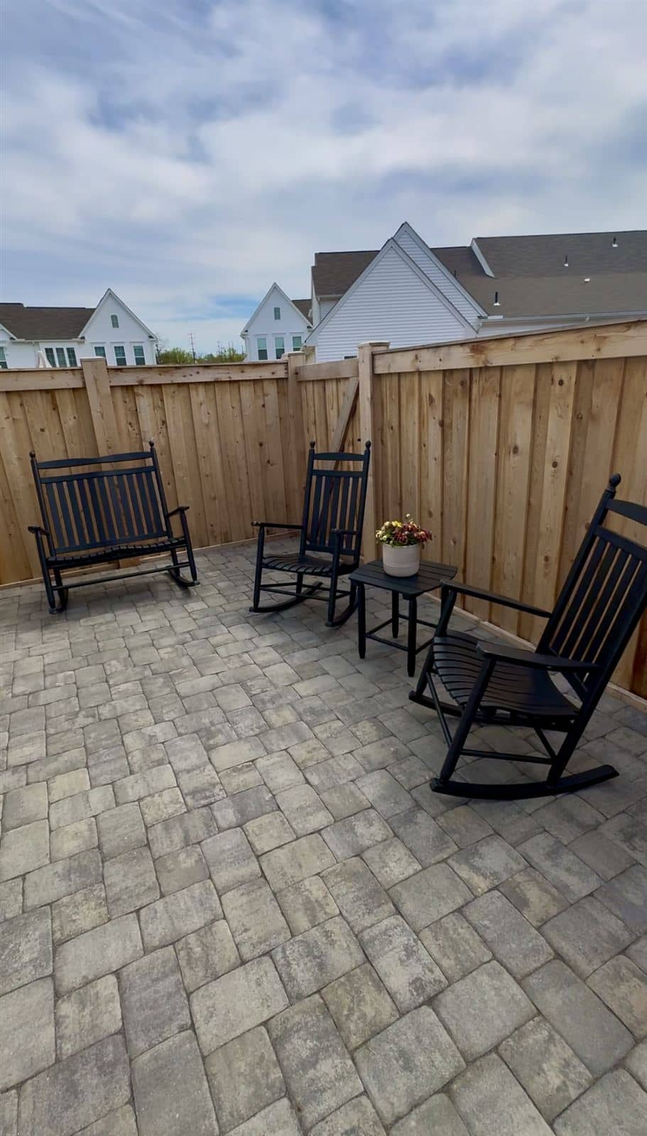 Townhouse backyard with patio, lawn, and finished planting after installation